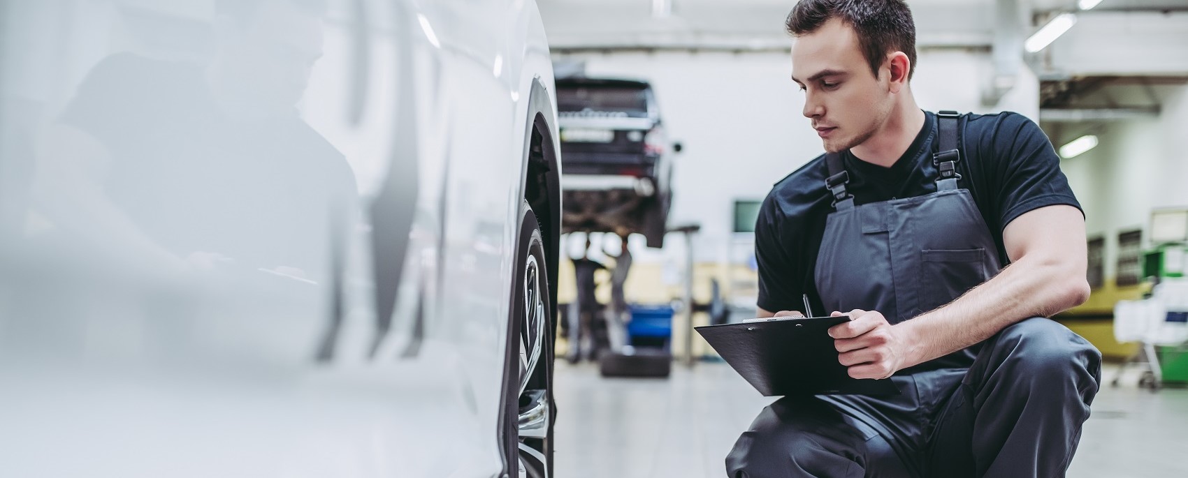 Technician Examining Body Panel Damange